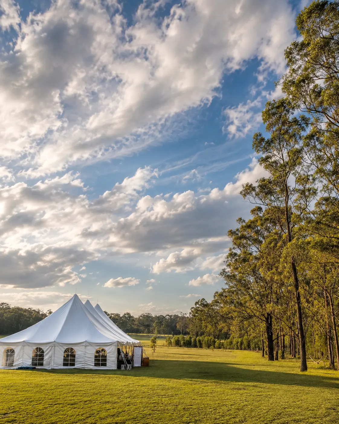 Wedding marquee set on open paddocks at Adeline Estate in late afternoon light