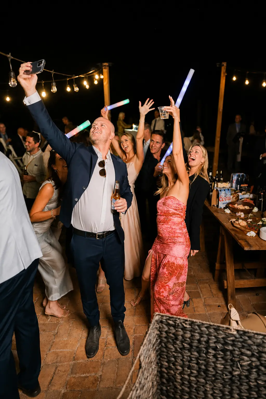 Wedding guests taking a late-night dance floor selfie