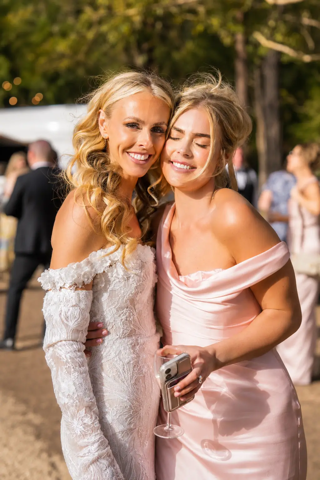 Bride embracing a guest during golden hour at Adeline Estate