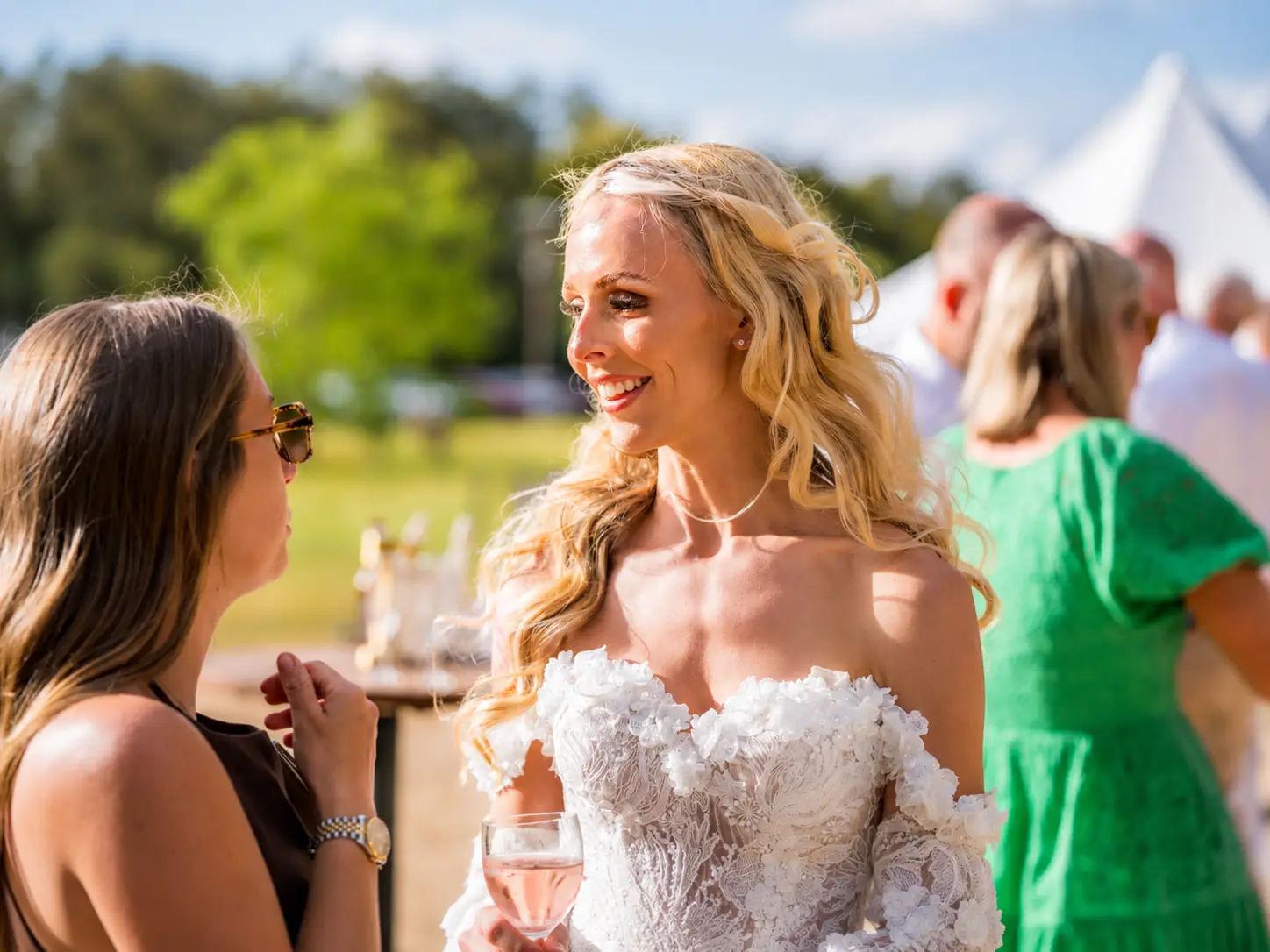 Bride talking with guests during cocktail hour at Adeline Estate