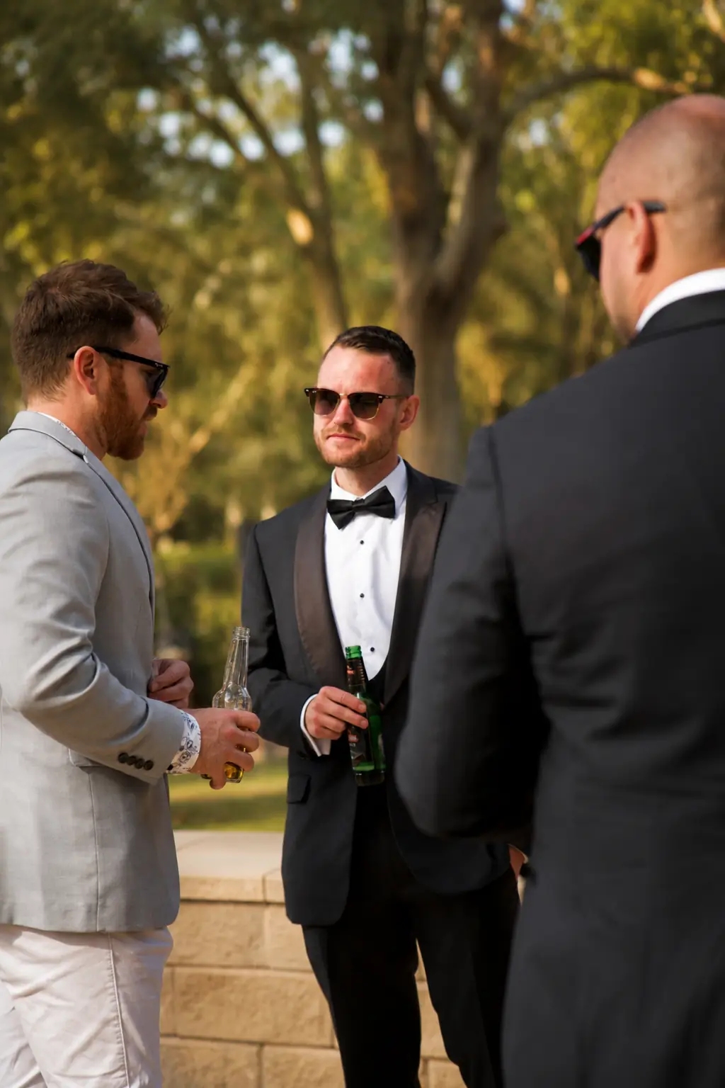 Groomsmen enjoying drinks before the reception