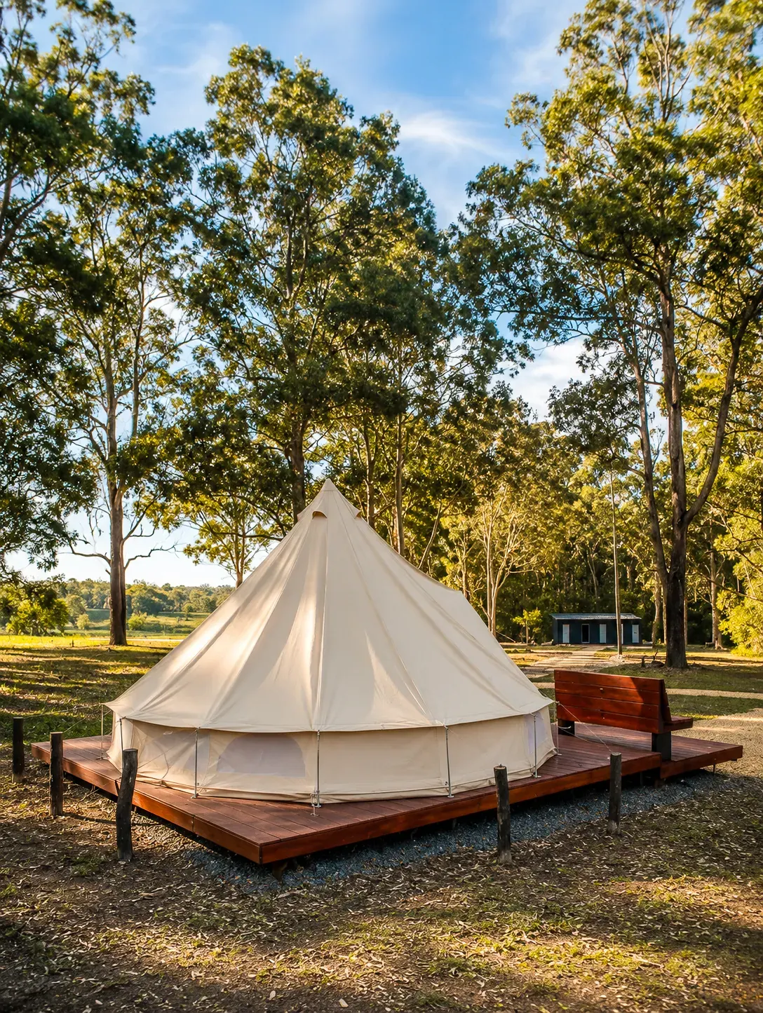 Furnished bell tent on a timber deck among gum trees at Adeline Estate